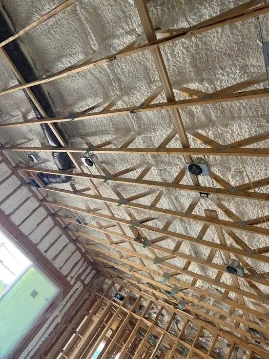 Spray foam coverage across an attic roofline