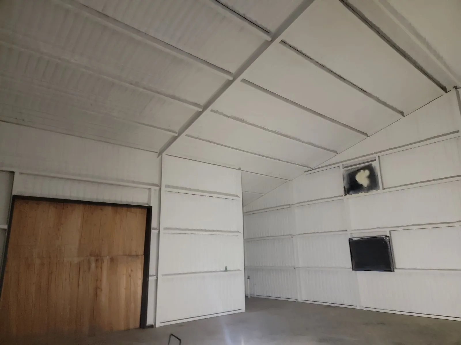 Metal building interior insulated with spray foam